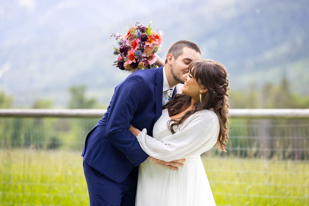 bride and groom hugging outside at their National Museum of Wildlife Art wedding